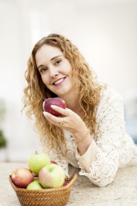 pretty lady smiling holding an apple