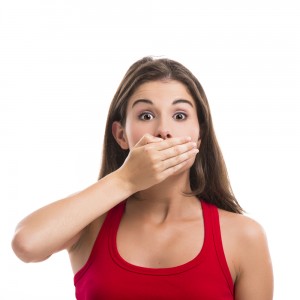pretty girl covering mouth with hands