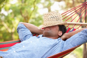 man relaxing in hammock