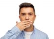 portrait of man covering mouth because of bad breath on white background