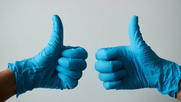 thumbs up in blue dental gloves thumbs up in blue dental gloves