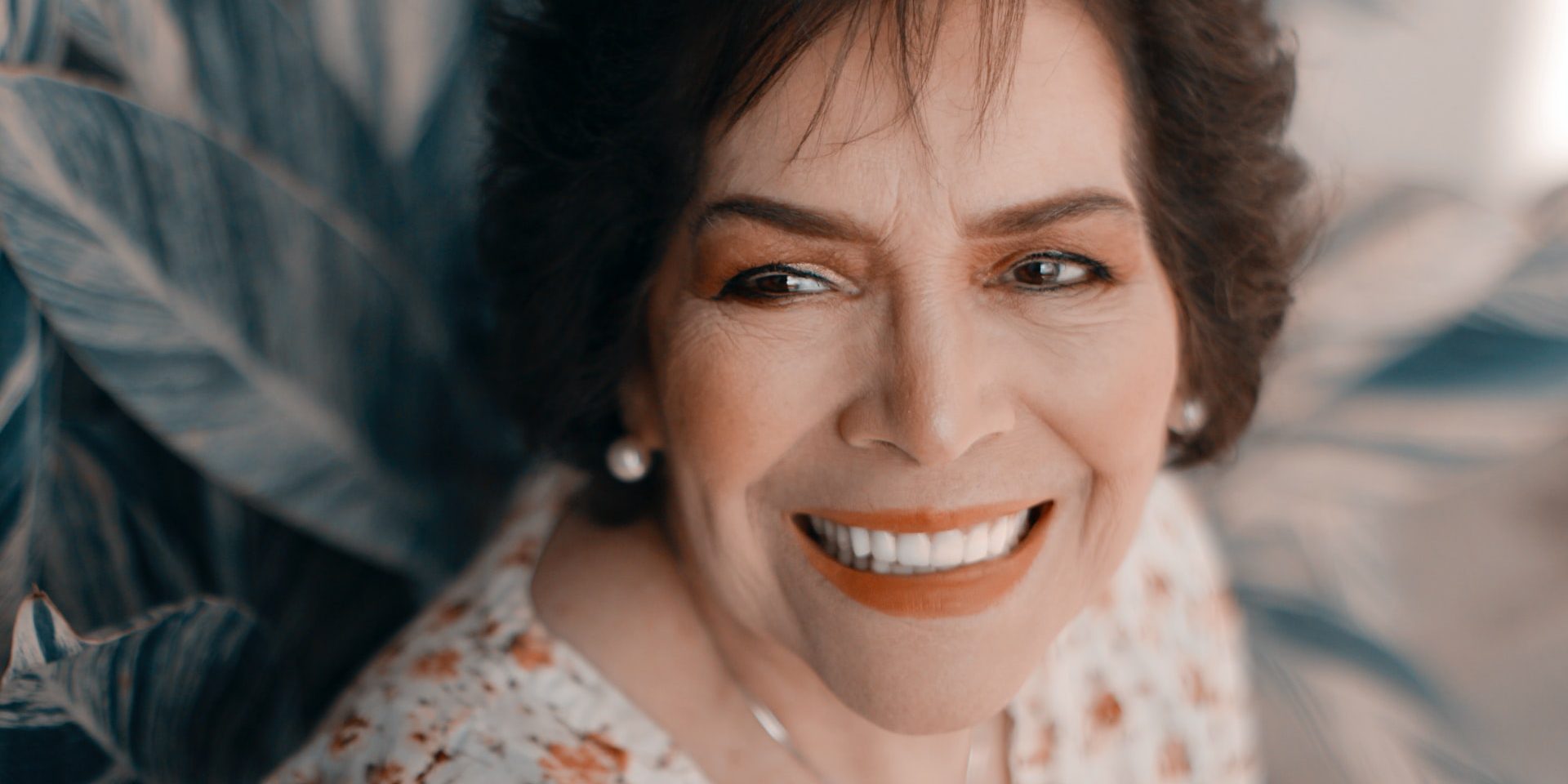 brunette woman smiling with leaves background brunette woman smiling with leaves background