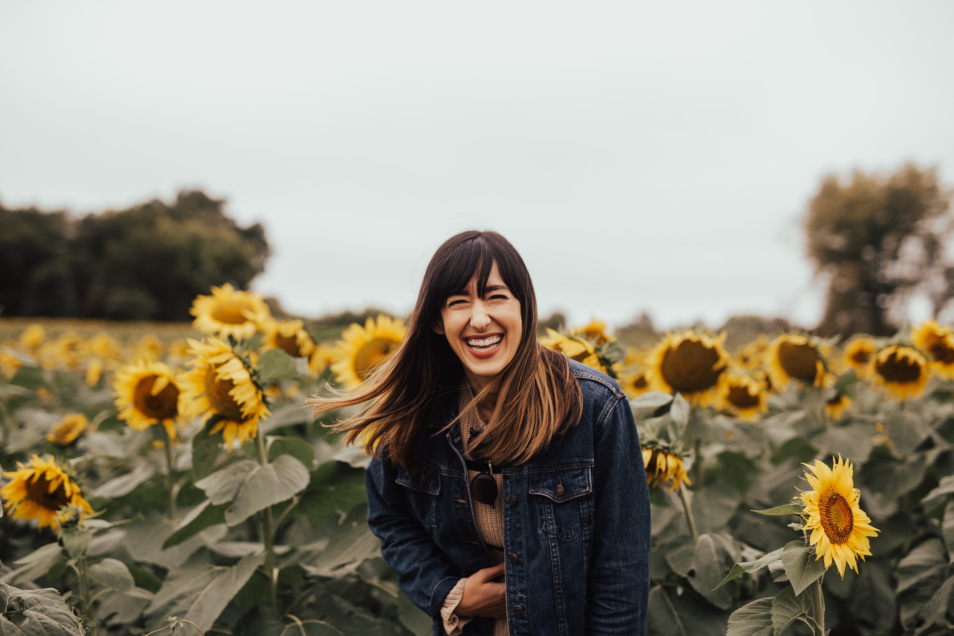 women smiling in sunflower field-restorative dentistry