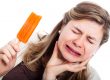 Woman eating ice cream experiences oral pain, indicating that she needs a dentist in lafayette, LA